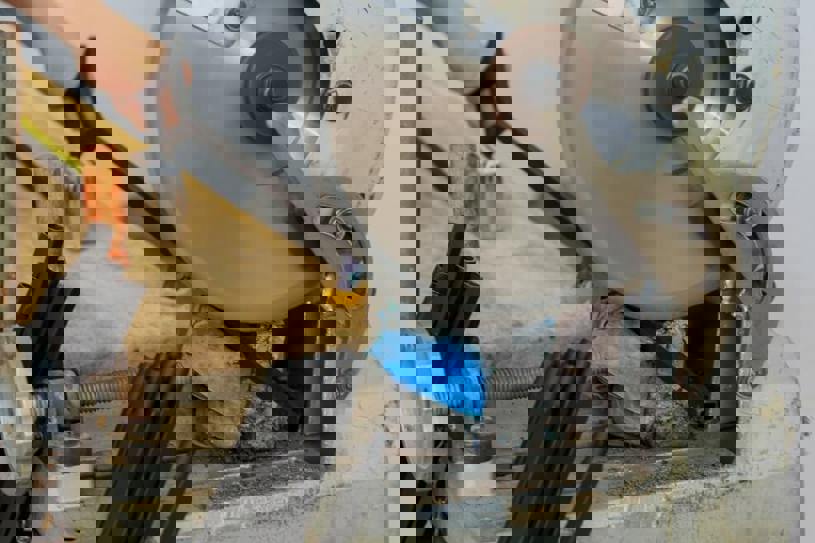 Chop saw cutting through metal railing