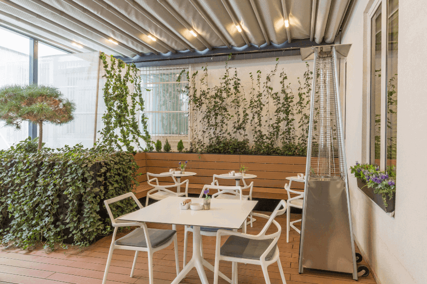 Patio with a heater next to the tables