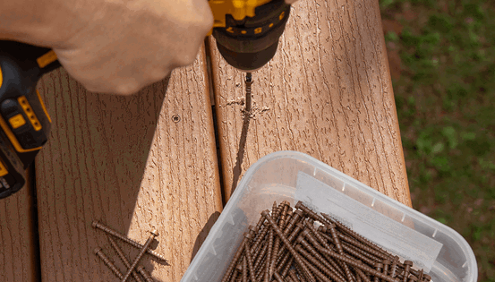 Image Person Drilling Screws Into Composite Deck Boards 2X