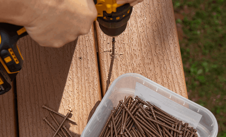 Image Person Drilling Screws Into Composite Deck Boards 2X