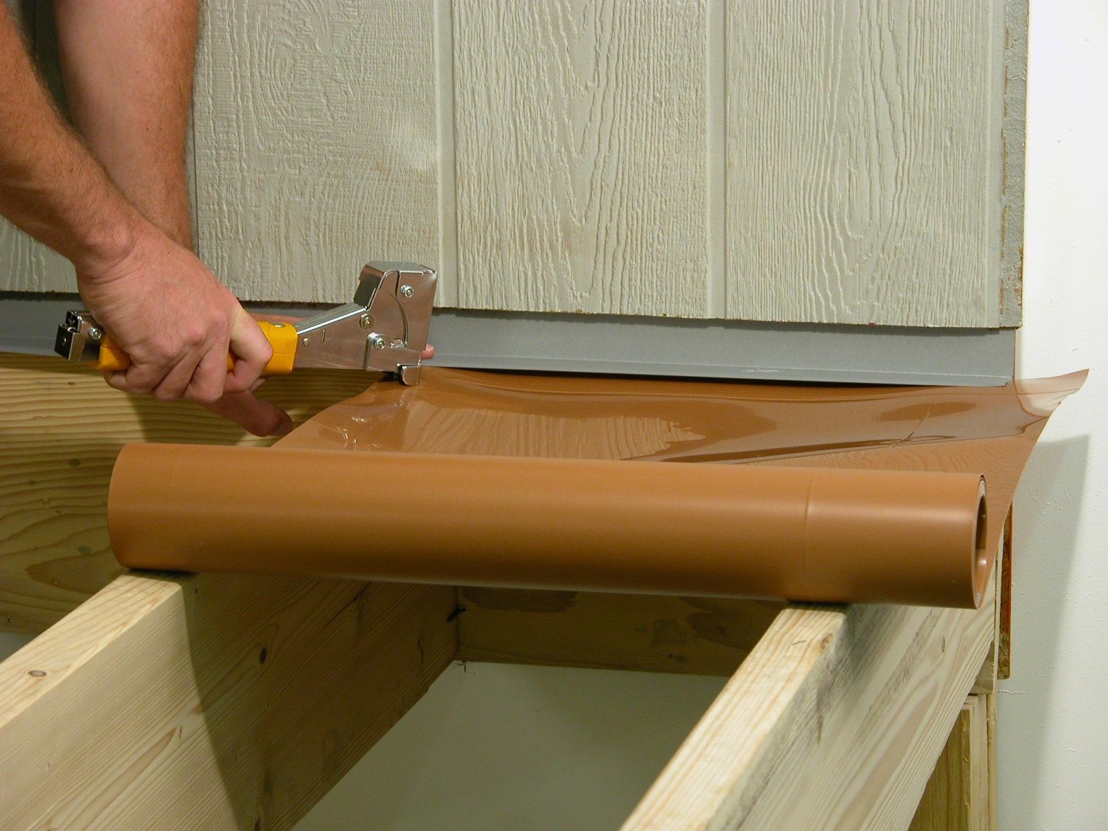 Tuck the trough under the flashing to the wall