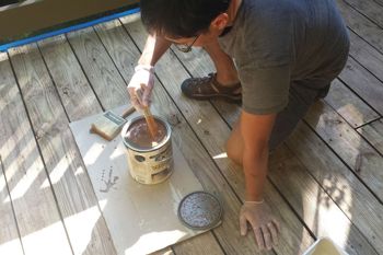 Mixing your wood stain with a stir stick.